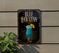 A sign for a Blue Hawaiian drink, featuring a blue cocktail with a pineapple garnish, is displayed on a wall.