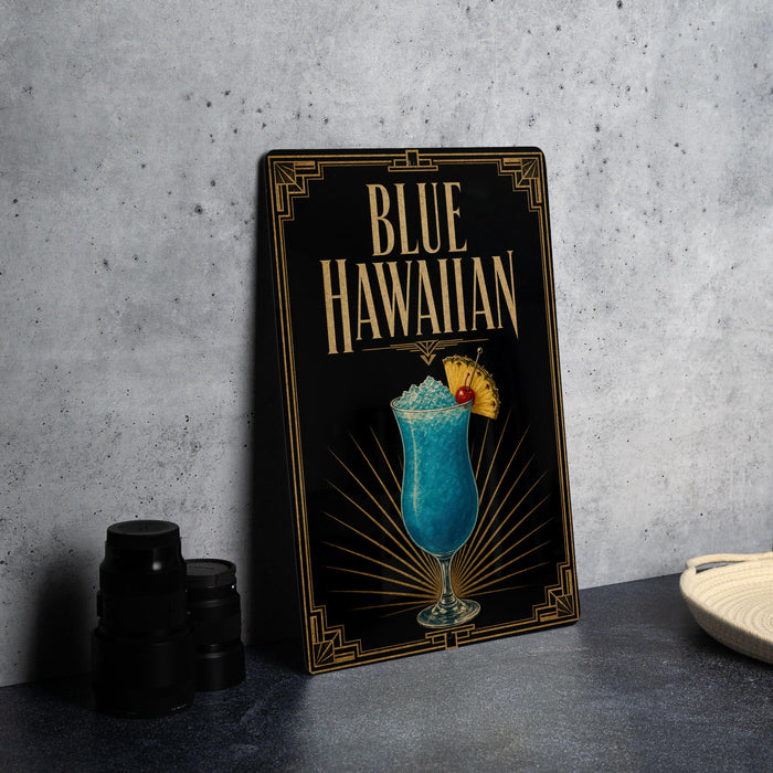 A framed poster or sign with the title "BLUE HAWAIIAN" and an illustration of a blue Hawaiian drink, likely a cocktail, on a black background with a decorative border.