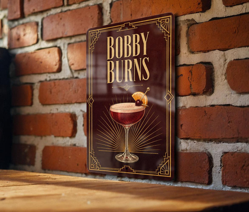 A decorative sign with the text "Bobby Burns" and an illustration of a cocktail glass with a cherry on top, mounted on a brick wall.