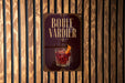 A sign with the text "BOULE VARDIER" and an illustration of a cocktail is displayed on a wooden wall.