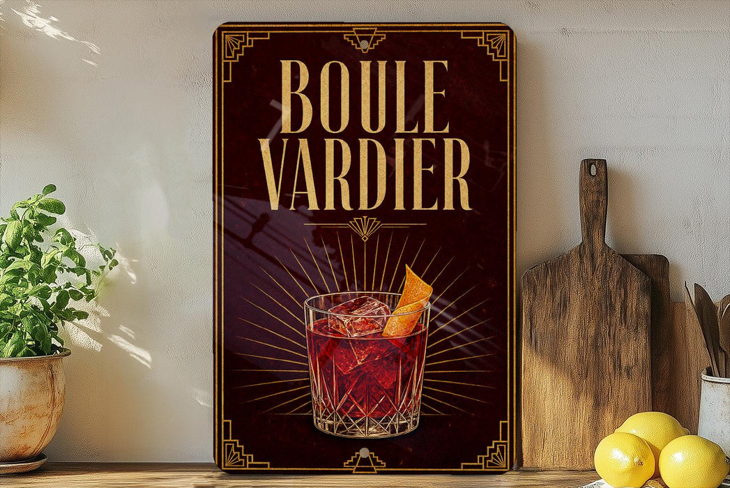 A framed advertisement for a drink called "Boule Vardier" featuring a glass of red cocktail with a lemon slice.