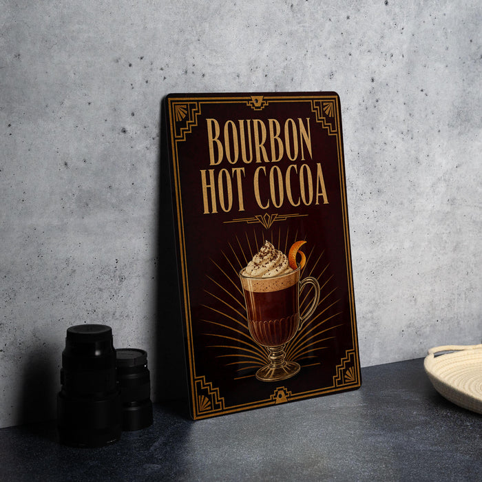 A framed advertisement for "Bourbon Hot Cocoa" featuring an illustration of a hot chocolate drink with whipped cream on top.