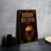 A framed advertisement for "Bourbon Hot Cocoa" featuring an illustration of a hot chocolate drink with whipped cream on top.