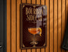 A sign that reads "BOURBON SIDECAR" with an illustration of a cocktail on a dark background.