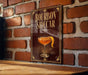 A poster or sign with the text "BOURBON SIDECAR" and an illustration of a cocktail glass with a lemon peel.