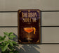 A sign for a cocktail called "Bourbon Sider" is displayed on a wall, featuring an illustration of a cocktail glass with a lemon peel.