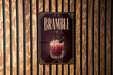 A sign for "Bramble" cocktail is displayed on a wooden wall.