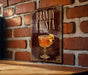 A framed poster or sign displaying a cocktail called "Brandy Crusta" with a glass illustration and a lemon peel.