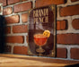 A sign for "Bandy Punch" is displayed on a brick wall, featuring an illustration of a glass containing a red-colored beverage with a slice of orange.