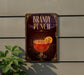 A sign for "Bandy Punch" is displayed on a wall, featuring an illustration of a glass containing a red-colored beverage with a slice of orange on the rim.