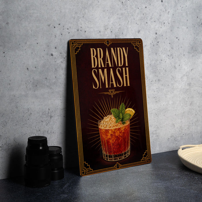 A framed advertisement for a "Brandy Smash" cocktail, featuring an illustration of a cocktail glass with a lemon slice and mint leaves.
