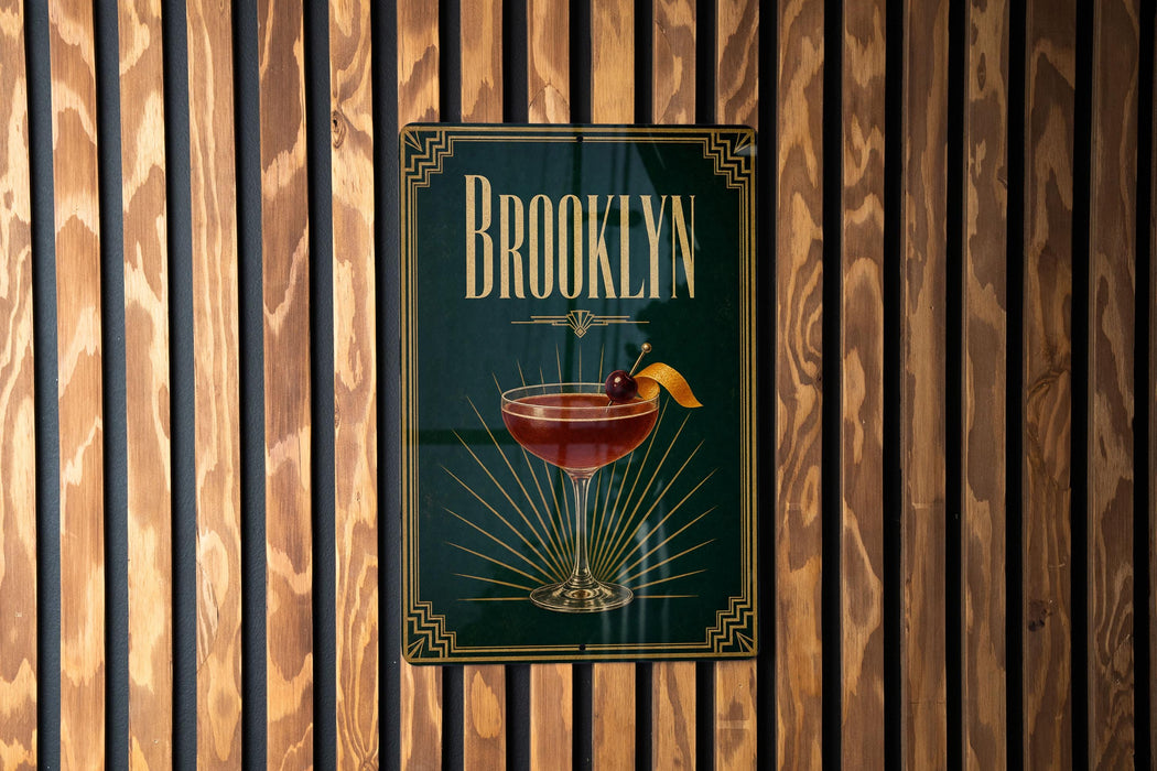 A poster with the word "Brooklyn" and an illustration of a cocktail is displayed on a wooden wall.