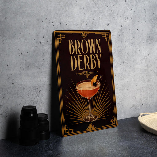 A framed poster with the title "Brown Derby" displayed prominently, featuring an illustration of a cocktail glass with a garnish.