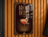 A sign for "Brown Derby" featuring a cocktail image and decorative elements.