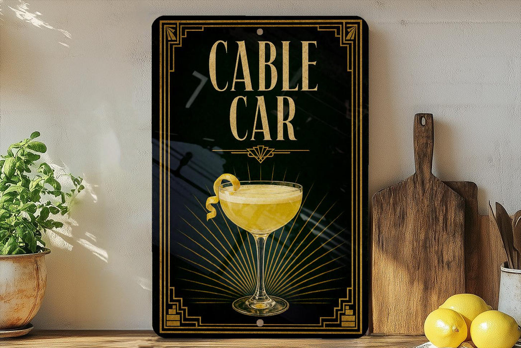 a sign for a cable car, with a glass of lemonade and a lemon on the side, placed on a wooden surface next to a cutting board and some lemons.