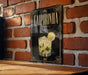 a sign with the name "CAIPIRÍNHÃO" and a cocktail illustration, hanging on a brick wall.