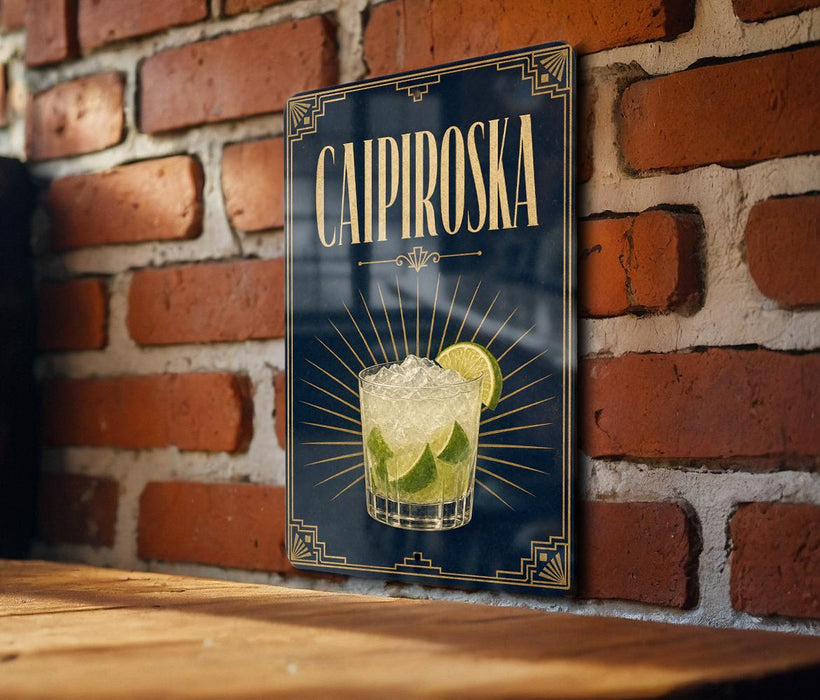 A poster or sign for a Caipiroski cocktail, featuring a glass of the drink with a lime slice, against a brick wall background.