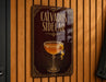 a sign that reads "Calvados Sidercar" and depicts a glass of wine with a lemon twist.