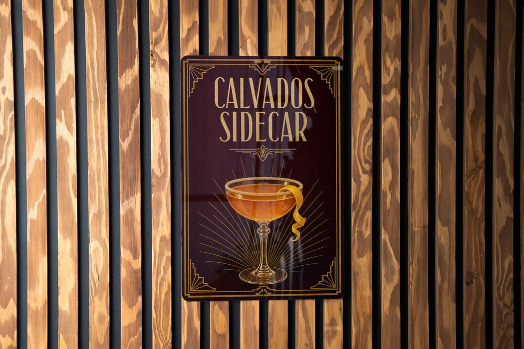 a sign with the text "CALVADOS SIDECAR" and an illustration of a cocktail glass with a lemon peel.