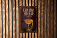 a sign with the text "CALVADOS SIDECAR" and an illustration of a cocktail glass with a lemon peel.