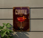 A decorative sign for a "Cardinal" cocktail, featuring a glass of red cocktail with a cherry on top, is displayed on a wall.