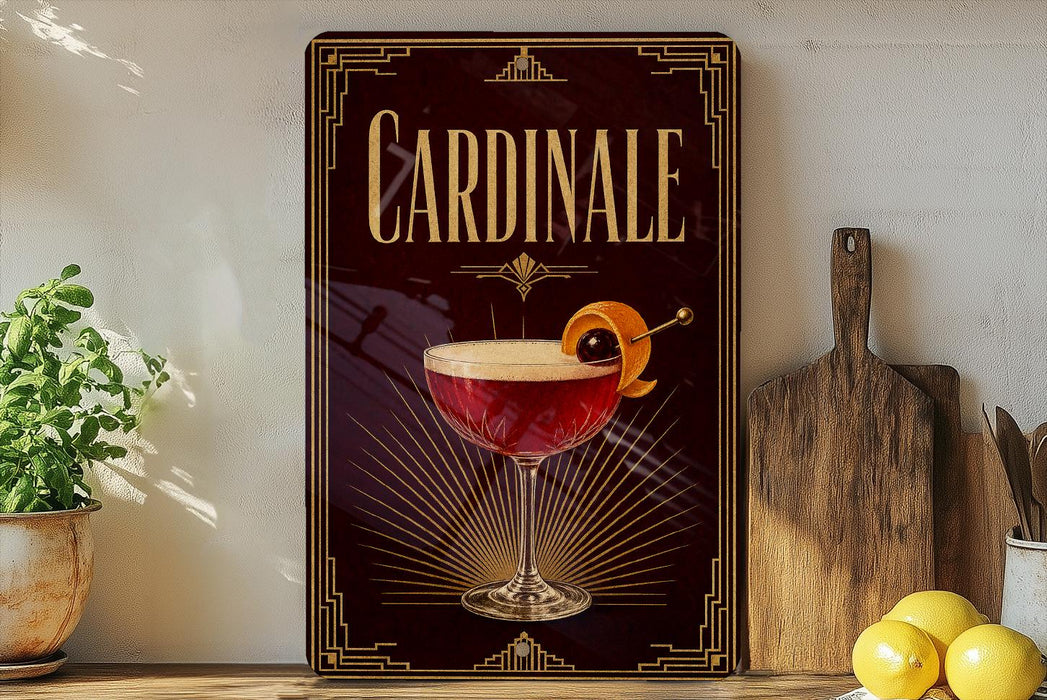 A decorative sign for "Cardinale" cocktail, featuring a glass of red cocktail with an orange twist and garnish, placed on a wooden surface next to a cutting board and a potted plant.