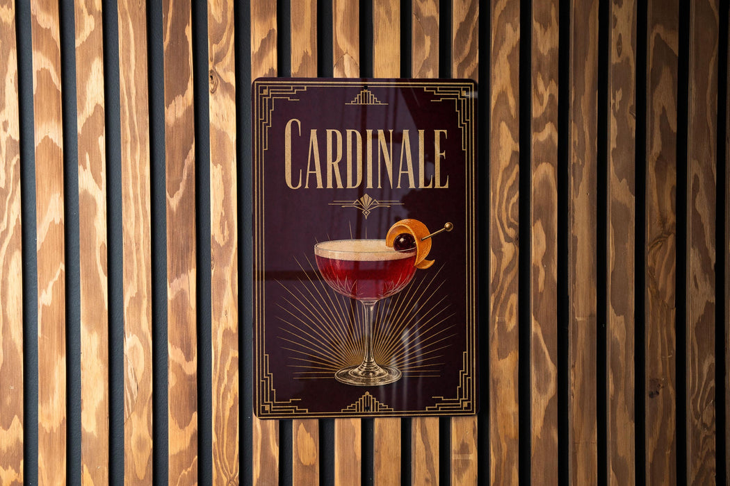 A sign for "Cardinale" cocktail is displayed on a wooden wall.