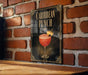 A sign for "Caribbean Punch" is displayed on a brick wall, featuring an illustration of a cocktail glass with a pineapple and a cherry on top.