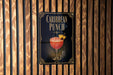 A sign for "Caribbean Punch" is displayed on a wooden wall.