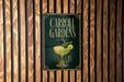 A sign for Carroll Gardens, featuring a cocktail glass with a lime garnish, is displayed on a wooden wall.
