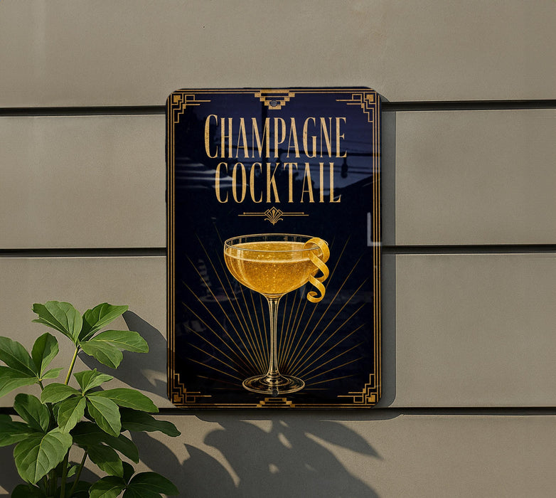A sign advertising a champagne cocktail is displayed on a wall, featuring an illustration of a champagne glass with a lemon twist.