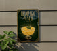 A sign for "Champagne Punch" is displayed on a wall, featuring an illustration of a champagne glass filled with a yellow liquid and garnished with a sprig of mint.