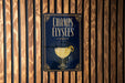 A sign with the text "CHAMPS ELYSEES" and an illustration of a cocktail glass with a lemon peel.