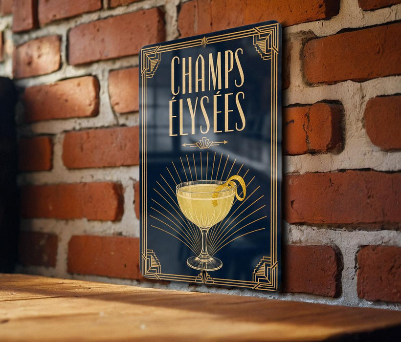 A decorative sign with the text "CHAMPS ELYSEES" and an illustration of a cocktail glass with a lemon peel.