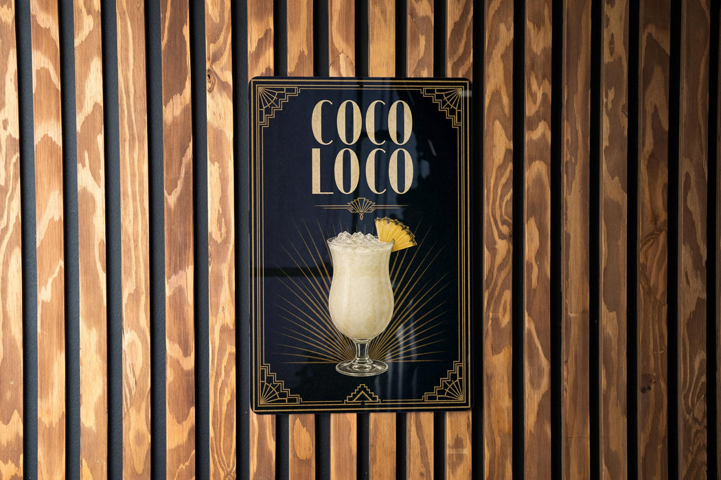 A poster for a drink called "Coco Loco" is displayed on a wooden wall.