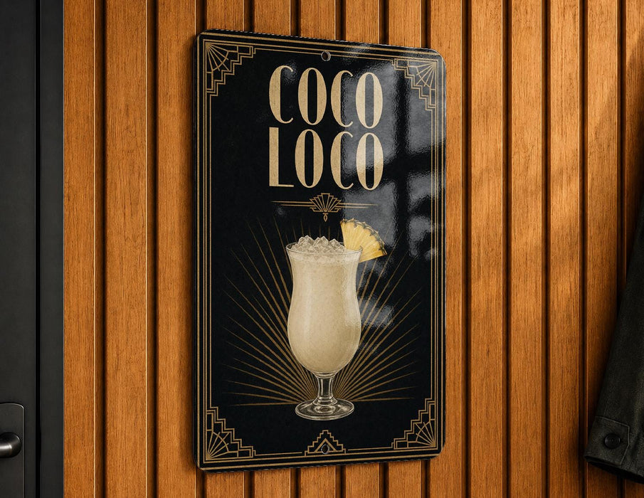 A sign for a cocktail called "Coco Loco" is displayed on a wooden wall.