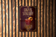 A sign for a cognac-sangaree cocktail is displayed on a wooden wall.