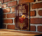 A sign for a drink called "Cognac Sangaree" is displayed on a brick wall.