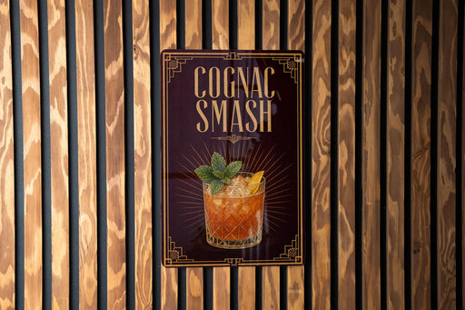 A sign for a cognac smash cocktail is displayed on a wooden wall.