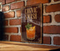 A sign with the text "Cognac Smash" and an illustration of a cocktail on a wooden surface against a brick wall background.