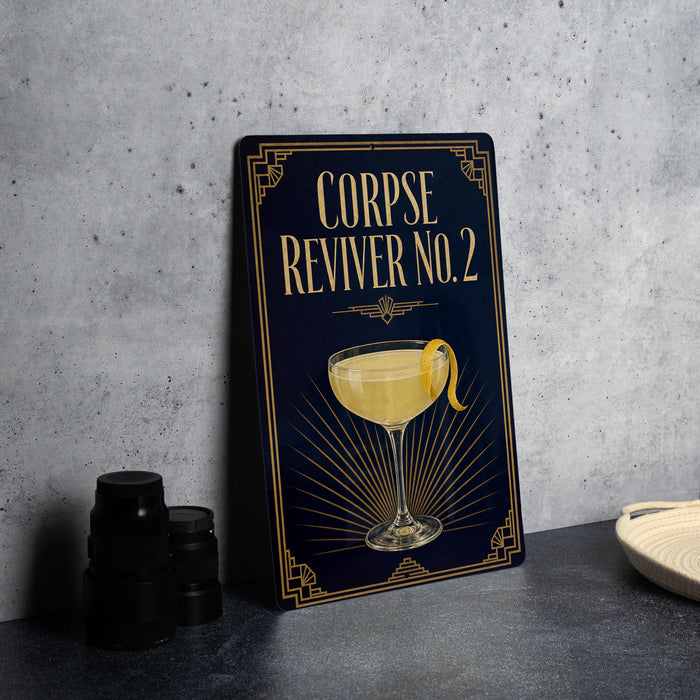 a metal sign with a decorative design, displaying a cocktail glass with a lemon twist, and the text "CORPSE REVIVER NO.2" on it.