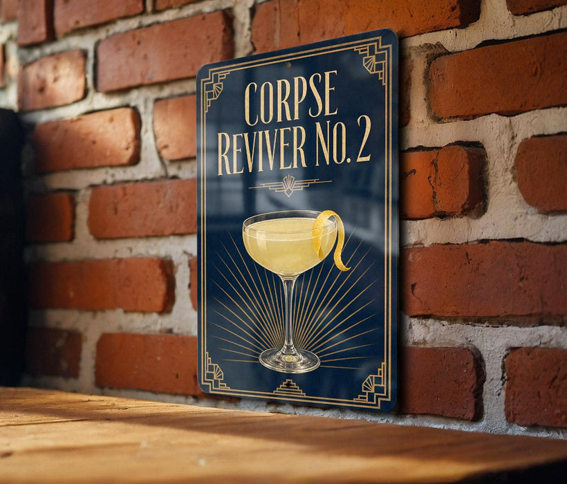 A sign with the text "CORPSE REVIVER NO. 2" and an illustration of a cocktail glass with a lemon peel.