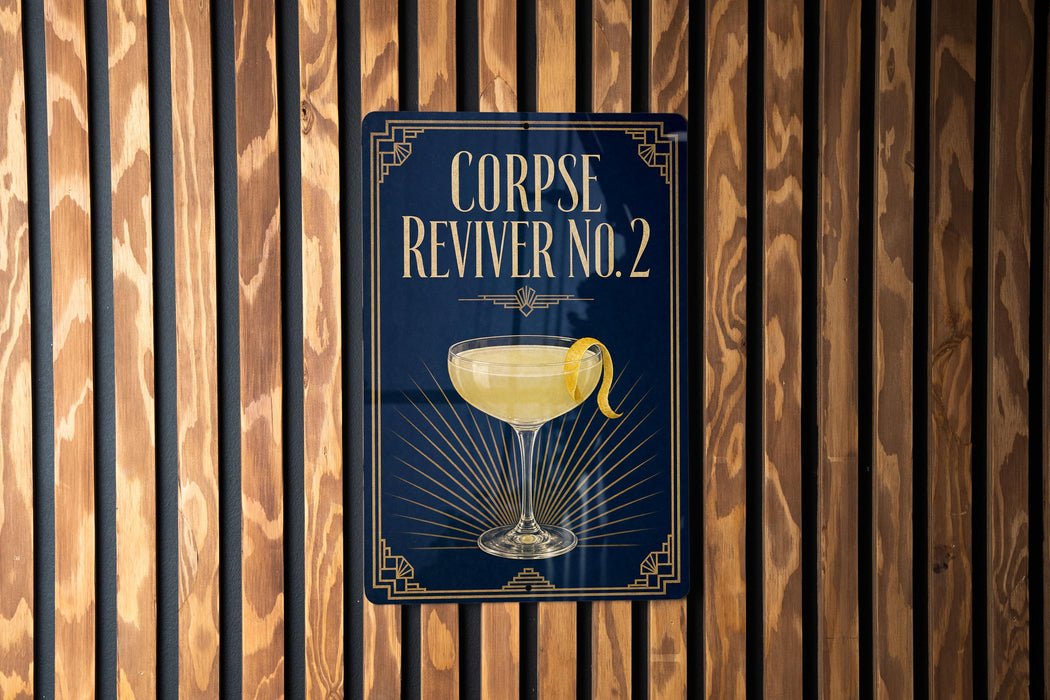 a sign with the text "CORPSE REVIVER NO. 2" and an illustration of a cocktail glass with a lemon twist.