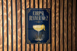 a sign with the text "CORPSE REVIVER NO. 2" and an illustration of a cocktail glass with a lemon twist.