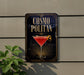 a sign for a cocktail called "Cosmo Politan" with a martini glass and a lemon on a wall.