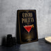 A decorative sign for a cocktail called "Cosmo Politan" is displayed on a table, featuring an illustration of a martini glass with a red drink and a lemon twist.