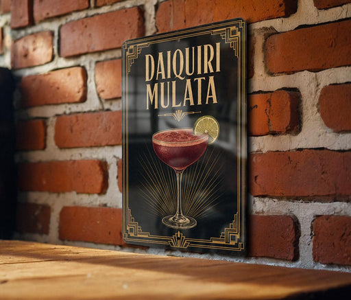 A decorative sign for a Daiquiri Mulata cocktail is displayed on a brick wall.