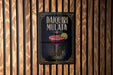 A decorative sign for a Daiquiri Mulata cocktail is displayed on a wooden wall.