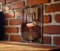 A sign with the text "DIAMOND BACK" and an illustration of a cocktail glass with a lemon on top, mounted on a brick wall.
