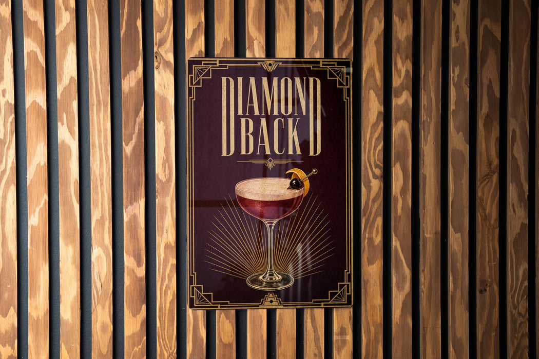 A poster with the title "DIAMOND BACK D" displayed prominently in the center, featuring an illustration of a cocktail glass with a garnish.